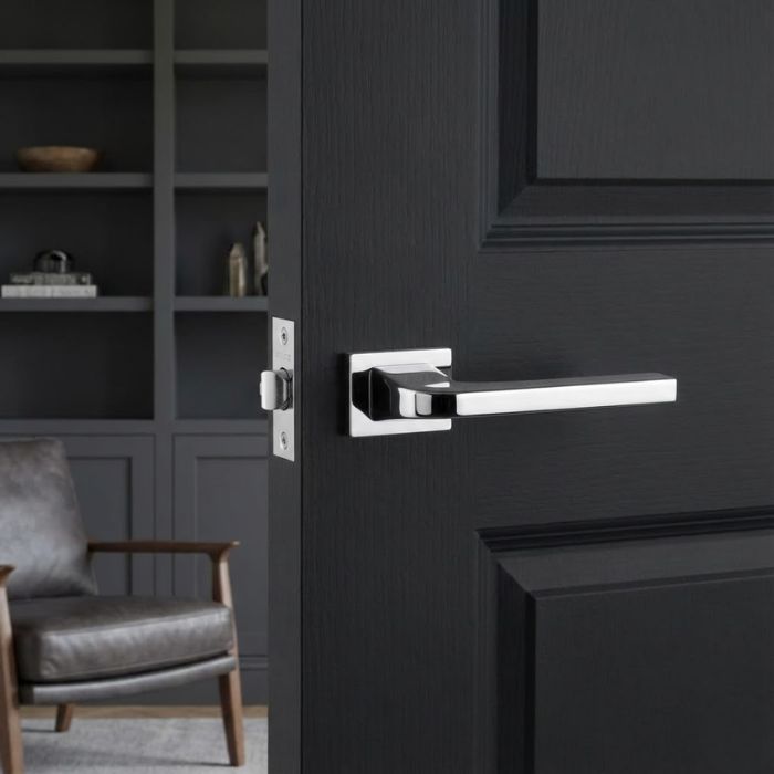 Ismena - Polished Chrome High-shine polished chrome exclusive rectangle door handles from the Ismena collection, creating a striking reflective accent on a dark charcoal grey door.