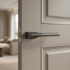 Lupina on Hidden Rosette hidden modern internal door handles in a dark graphite finish, featuring a sharp geometric profile on a light grey timber door.