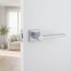 Ninfea on Square Rosette sophisticated square door handles featuring a sleek satin chrome finish on a clean, minimalist white interior door.