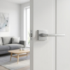 Pyrola on Square Rosette understated square door handles in a smooth satin chrome finish, installed on a minimalist white door.