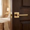 Luxurious polished gold classic square internal door handles from the Setia range, mounted on a rich dark wood door for a sophisticated aesthetic.