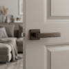 Sleek square internal door handles in a deep brown metallic finish from the Sulla on Square Rosette collection, mounted on a neutral taupe door.