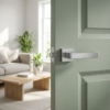 Sulla on Square Rosette sleek square internal door handles in a smooth satin chrome finish, mounted on a soft sage green panelled door.
