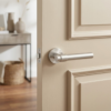 Contemporary internal door handles in a soft pearl silver finish from the Bellisa range, mounted on a neutral beige door for a modern look.