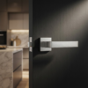 Alisso on Square Rosette designer square door handles in a modern brushed chrome finish, mounted on a sleek black interior door.