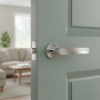 Elegant internal door handles displaying the Alora lever on a round rosette in polished chrome, reflecting light within a modern interior setting.