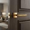 Minimalist internal door handles in PVD gold, displaying the Arabis lever on a square rosette for a clean, luxury interior look