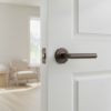 Sleek door handles for internal doors showcasing the Arabis on Round Rosette in a brown finish, paired with a contemporary interior setting.