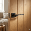 Bergenia on Square Rosette in matt black, a bold and elegant door handle for internal doors fitted to a vertical oak door.