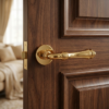 Stylish internal door handles – Camelia on Round Rosette in polished gold, showcasing an elegant traditional lever on a rich wooden internal door.