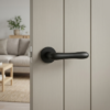 Cynia on Round Rosette in matt black, luxury lever internal door handles displayed on a contemporary neutral-toned door.