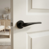 Dalia on Round Rosette in matt black finish, showcasing sleek designer internal door handles on a modern white door.