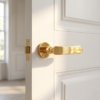 Deglasia on Round Rosette in polished gold finish, featuring high-end internal door handles on a white interior door with elegant detailing.