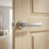 Fragola on Round Rosette luxury round internal door handle in satin chrome on a natural oak door.