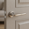 Elegant round internal door handle in polished chrome Funkia design fitted to a light wood door in a contemporary home interior.
