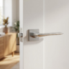 Understated internal door handles shown in brushed chrome, featuring the Iris on Square Rosette with a slim lever design on a white internal door in a softly styled living space.