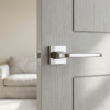 Ismena luxury square internal door handles in polished chrome, highlighting clean square lines and a reflective finish on a modern internal door.