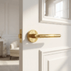 PVD gold Kalmia on Round Rosette featured on a white internal door, highlighting its sleek round internal door handle style in a luxurious modern setting.