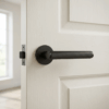 Sleek internal door handles in a matt black finish, showcasing the Kerria handle on a round rosette against a white internal door.