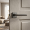 Sleek graphite Lila on Square Rosette minimalist square internal door handles featuring a dark grey metallic tone on a light wood door.