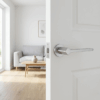 Delicate round internal door handles – Ninfea on Round Rosette in satin chrome, shown on a white internal door in a minimal contemporary living space.