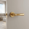 Rosemary on Round Rosette in polished gold, showcasing classic round internal door handles on a light interior door.