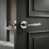 Polished chrome Verbena on Round Rosette showcasing premium round door handles on a dark internal door.