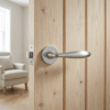 Satin chrome Verbena on Round Rosette installed on a natural wood internal door, highlighting premium round door handles.