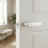 Sorella on Hidden Rosette in satin nickel, a sleek contemporary door handle design on a white interior door.