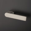 Sorella on Hidden Rosette in satin nickel, full handle view with integrated lock on a dark background.